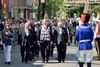 А это король собственной персоной. Обходит все подразделения перед началом парада. У него за спиной в синей шляпке маячит мадам-бургомистр нашего города.